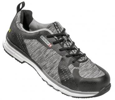 The shoe is a comfortable, sporty sneaker in black and gray. It has a breathable surface with mesh parts and a sturdy sole for good grip. It is ideal for activities.