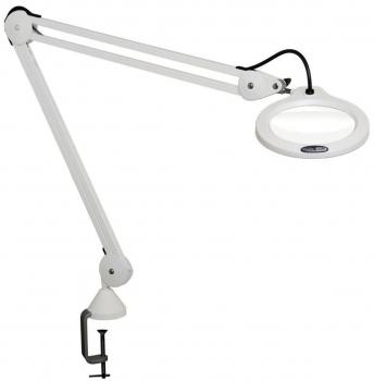 The image shows a white desk lamp with a flexible arm and a large round lens. It is attached to the desk with a clamp and provides bright light for precise tasks.