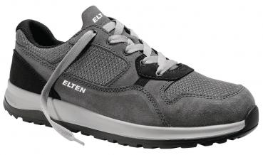 Der Schuh ist ein grauer Sneaker mit einem Obermaterial aus Textil und Wildleder. Er hat eine weiße Sohle, schwarze Details und graue Schnürsenkel. Die Marke ?ELTEN? ist an der Seite zu sehen.