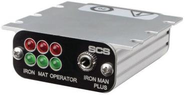 The image displays a rectangular electronic control panel with a metal and black surface. It features several green and red lights, a connector, and labels.