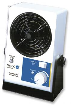 The image shows a small fan in white and black. It has a round grille, a rotary knob for speed adjustment, and a flat, rectangular base.
