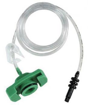 The image shows a green connector with a hose. The hose is transparent, thin, and curved. The connector has a clip and a black connection at the end of the hose.
