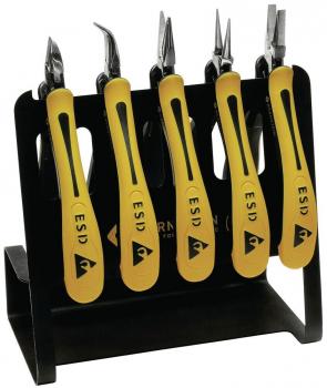 The image shows a black holder containing five electronic pliers with yellow handles. Each pair of pliers has a different shape for precise work. They feature the ESD logo.