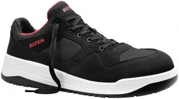 The shoe is a sporty sneaker in black with a stiletto heel. It features a mesh-like upper, gray laces, and a thick white sole. The interior color is red.