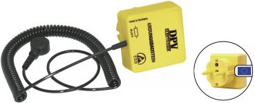 The image shows a yellow device, possibly a grounding block, with a spiral cable. Next to the main device, an enlarged detail of the connector socket is displayed.