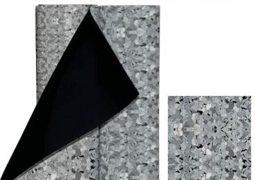 The image shows a roll of gray, textured material containing small, light and dark particles. Part of the roll is unrolled, revealing the black backside. Beside the roll, there is a smaller piece of the material.