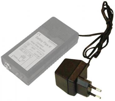 The image shows a gray power supply with a label on the top. It has a long cable and a small plug for an outlet. The shape is rectangular and compact.