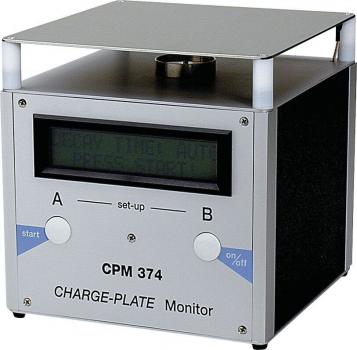 The image shows a compact, rectangular device with a digital display on the front. It has two large buttons labeled 