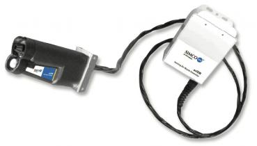 The image displays a technical device featuring a long, black handle and a connecting cable. At one end, there is a block marked with the inscription 