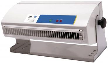 The image displays a technical device, likely an air purifier or cooker. It is rectangular with a front made of thin strips for air circulation and features control lights and a rotary dial.