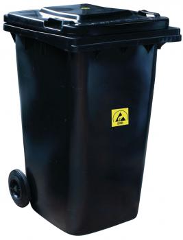 The black trash can has two wheels and a lid. On the front, there is a yellow warning symbol. It is rectangular and about hip-high.