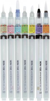 The image shows a transparent felt-tip pen with a fine tip. It has a white body and a brown cap. Small inscriptions and symbols can be seen on the pen.
