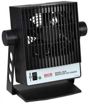 The image shows a black tabletop air purifier with a rectangular, grid-like fan. It has a stable base and lights up green when it is turned on.