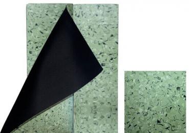 The image shows two rectangular plates. One is green with small, dark specks. The other is black and is partially covered by the green plate.
