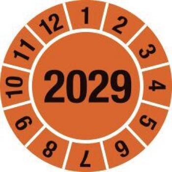 The image shows a round sticker with an orange background. In the center is the large number "2029". Around it, the numbers 1 through 12 are arranged.