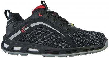 The shoe is a black, low-cut sneaker with red-black accents. It features a breathable upper material structure, a comfortable sole, and laces for good support.