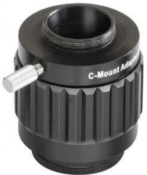 The image shows a C-mount adapter made of black lacquered metal. It has a round shape with a grooved edge and a side screw for securing. The opening on top is continuous.