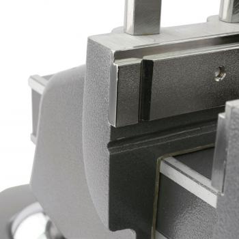 The image displays a section of a mechanical device, likely a precise mount. The surface is smooth and metallic, with sharp edges and textured areas.