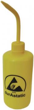 The image shows a yellow bottle with a long, narrow spout. On the bottle, there is a black logo featuring a triangle and the text 
