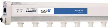 The image displays a long, rectangular device in light colors. It has multiple outputs on the bottom and controls on the front, as well as blue lettering with the name 