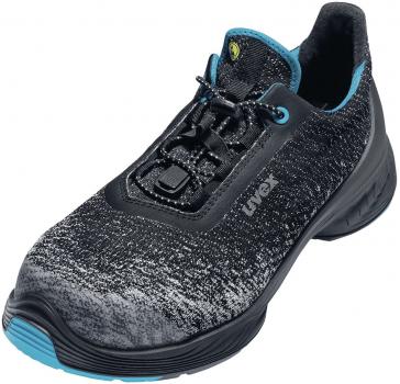 The shoe is sporty, with an upper in black and gray shades that appears mottled. Accent colors in blue are on the tongue and the laces. The sole is sturdy and slightly elevated.