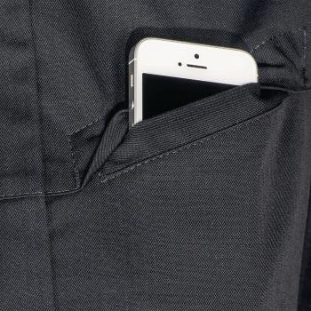 In the picture, a smartphone is visible in a dark pocket. Only the top part of the phone sticks out, and the screen is black. The pocket has a clear, simple seam.