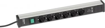 The image shows a power strip with six black outlets. On the left side, there is a green switch to control the electricity. The rest is plain and metallic.