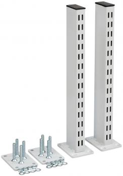 The image shows two tall, rectangular white metal bars standing vertically. Next to them are various metal parts and screws used for mounting.