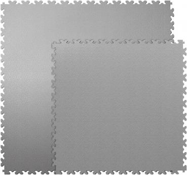 The image displays a matte, green surface with a jagged edge, next to which lies a piece of black fabric. The mat has a textured surface that appears to be slip-resistant.