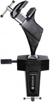 The image shows a sturdy metal table vise. It has a solid body with two clamping surfaces, which are pressed against each other with a screw.