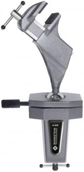 The image shows a sturdy metal table vise. It has a solid body with two clamping surfaces, which are pressed against each other with a screw.