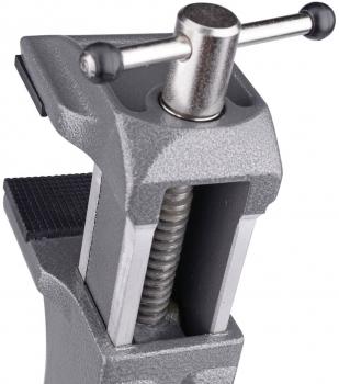 The image shows a gray vise. It has two jaws that can be opened and closed, and a large screw in the center that is used for tightening.