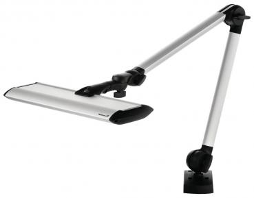 The image shows a modern desk lamp with a long, adjustable arm. The lampshade is flat and elongated, in silver color, attached to a sturdy base.
