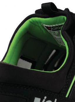 The image shows the interior of a black shoe with green lining. The sole is well-cushioned and provides comfort. A label with information is visible.