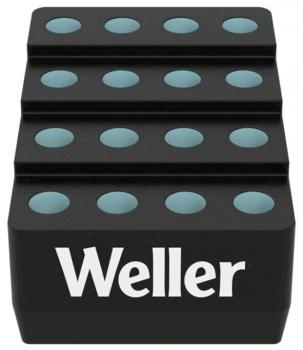 The image shows a black holder with three tiered levels. On each level, there are several round, slightly raised depressions in turquoise. The inscription 