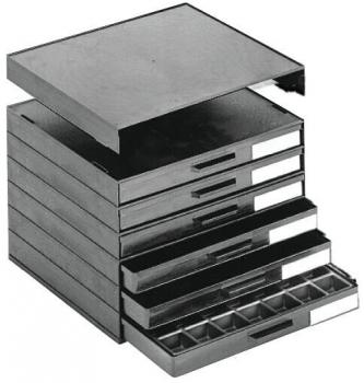 It is a square, flat metal tray. It has straight edges, slightly raised borders, and a smooth surface. On one side, there is a small handle.