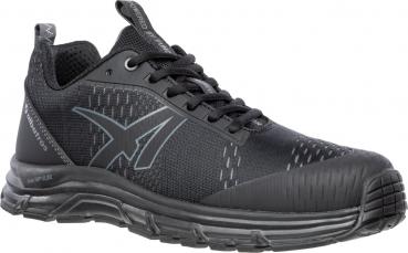 The shoe is a black sneaker with a textured surface, reinforced toe area, and a flexible rubber sole. It has black laces and a sporty shape.