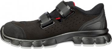 A black athletic shoe with a reinforced sole and two adjustable Velcro straps. The shoe features a breathable upper and a light, flexible structure.