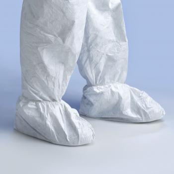 The image shows a pair of white overshoes made from a lightweight, foldable material. They are large and loosely cut to fit over regular shoes. The background is blue.