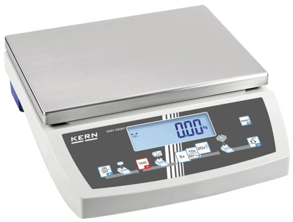 The digital scale has a flat, rectangular stainless steel surface on top. Beneath it is a display with blue digits and control buttons in various colors.