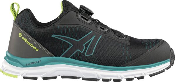 The shoe is sporty and modern, predominantly black with green accents. The surface is textured, and the sole is stable and flexible, ideal for outdoor activities.