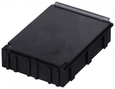 The image shows a rectangular, flat black box with a smooth lid and a small metal clasp. The sides are slightly raised and have a serrated pattern.
