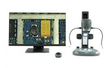 In the image, on the left there is a monitor displaying a close-up of a circuit board, and on the right a microscope with several connections and a sturdy base.