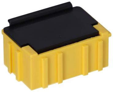 Das Bild zeigt einen rechteckigen, gelben Stecker oder eine Box mit einer schwarzen Abdeckung oben. Die Seiten sind strukturiert mit vertikalen Rillen. Die Form ist kompakt und robust.