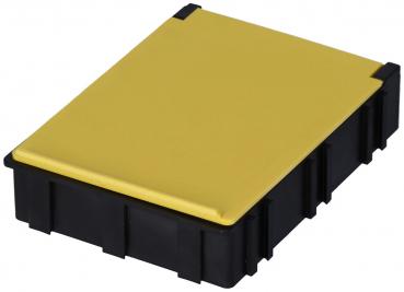 The image displays a rectangular box with a black body and a yellow lid. The top is smooth, while the sides are textured, conveying a sturdy appearance.