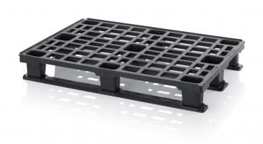 The image shows a black plastic pallet. It has a grid-like structure with several square openings and four sturdy feet on the sides.