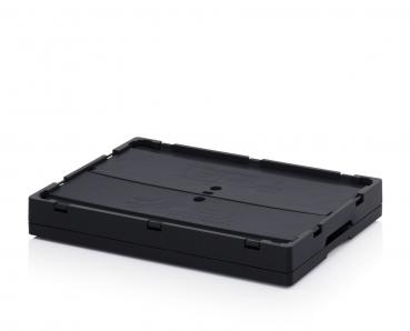 The image shows a rectangular, flat box made of black plastic. It has a smooth surface with slight patterned textures and rounded corners. There are two small holes in the center.
