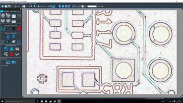 The image shows an enlarged view of a circuit board. Various electronic components and circuits are visible, including square and round formations that are interconnected.