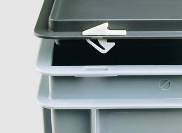 The image shows stackable, rectangular containers in gray and light gray with a lid. A small white clip on a lid is visible, which serves as a fastener.
