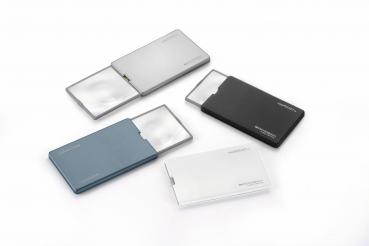In the picture, there are four slim card cases in different colors (gray, blue, black, and white). Two of the cases are open and display integrated mirrors.